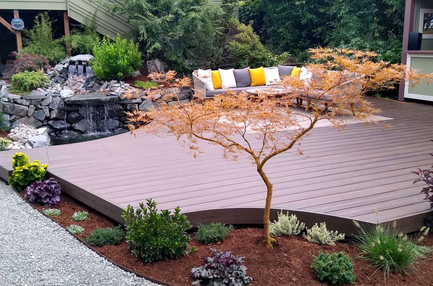 Cedar deck with built-in seating and a water feature in a Pacific Northwest garden