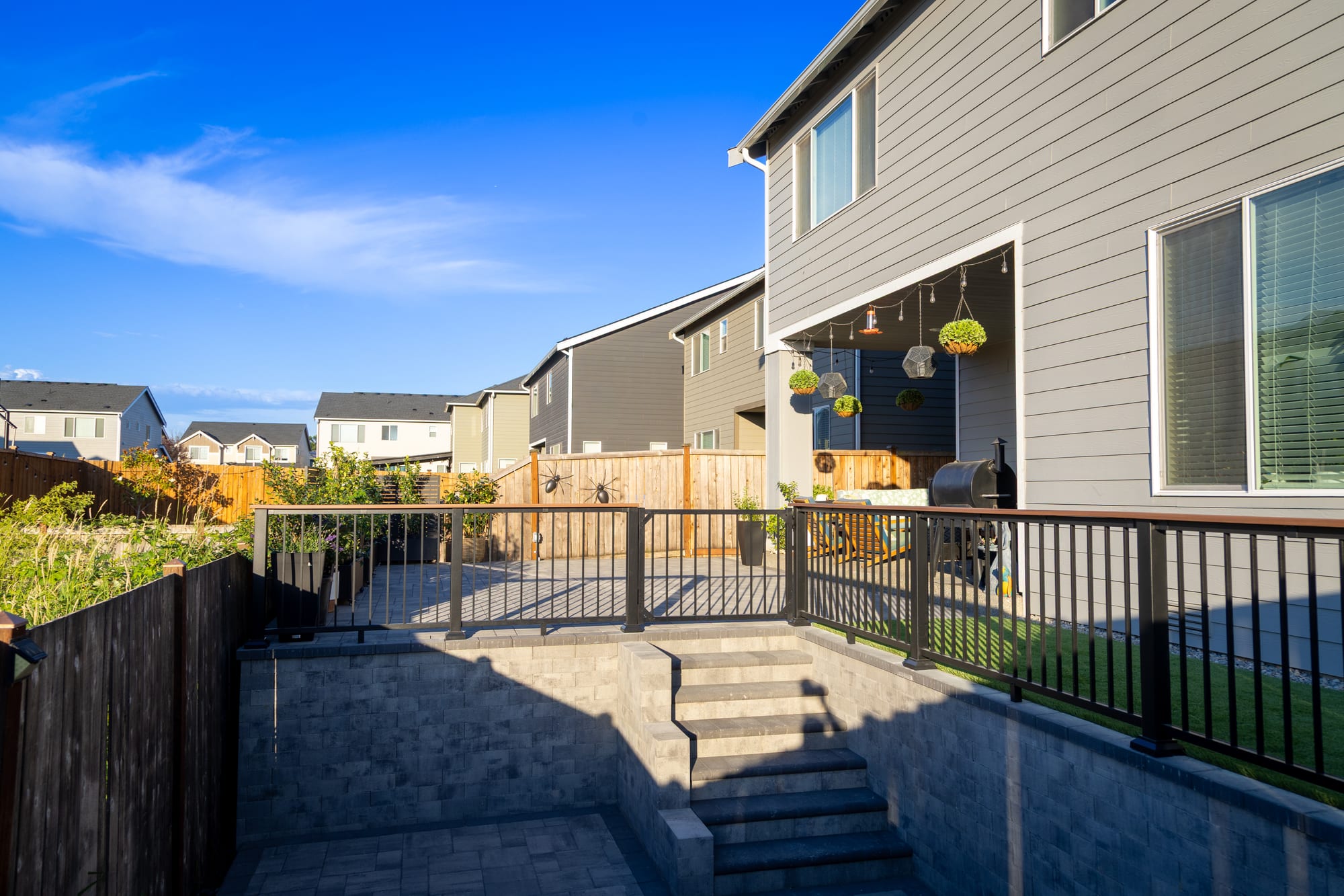 Looking up the bullnose paver steps from the lower hot tub patio to the upper entertaining level