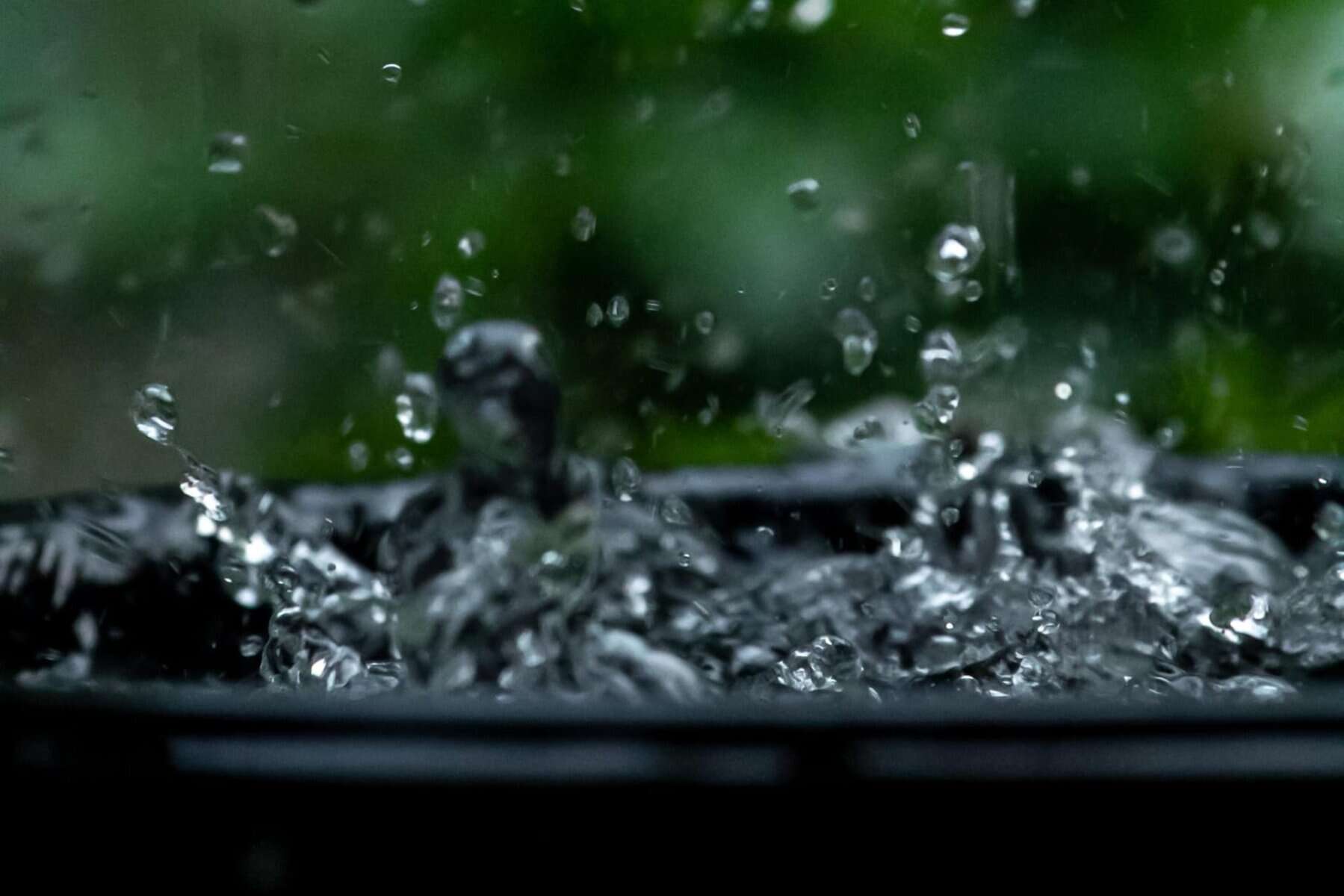 water splashing in a barrel in DIY Rainwater Collection Systems