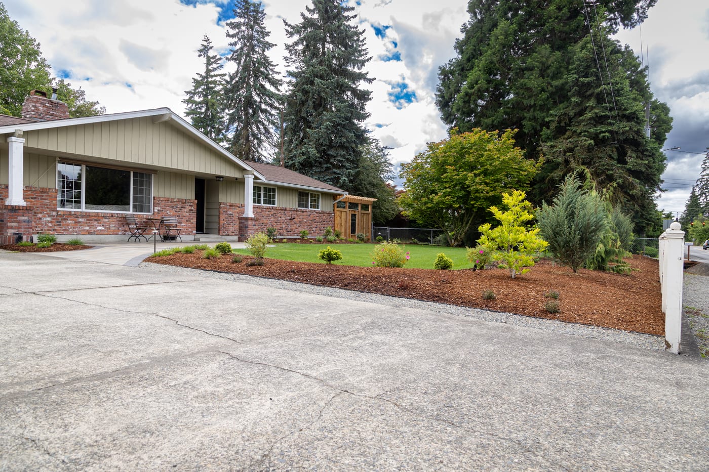 Renovated front yard with fresh plantings and restored curb appeal