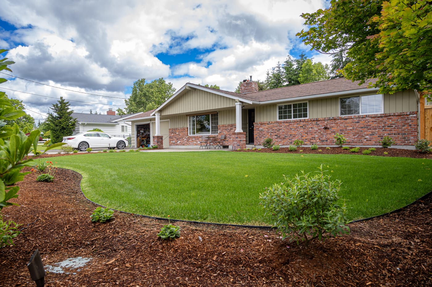 Fresh curved planting beds along the house