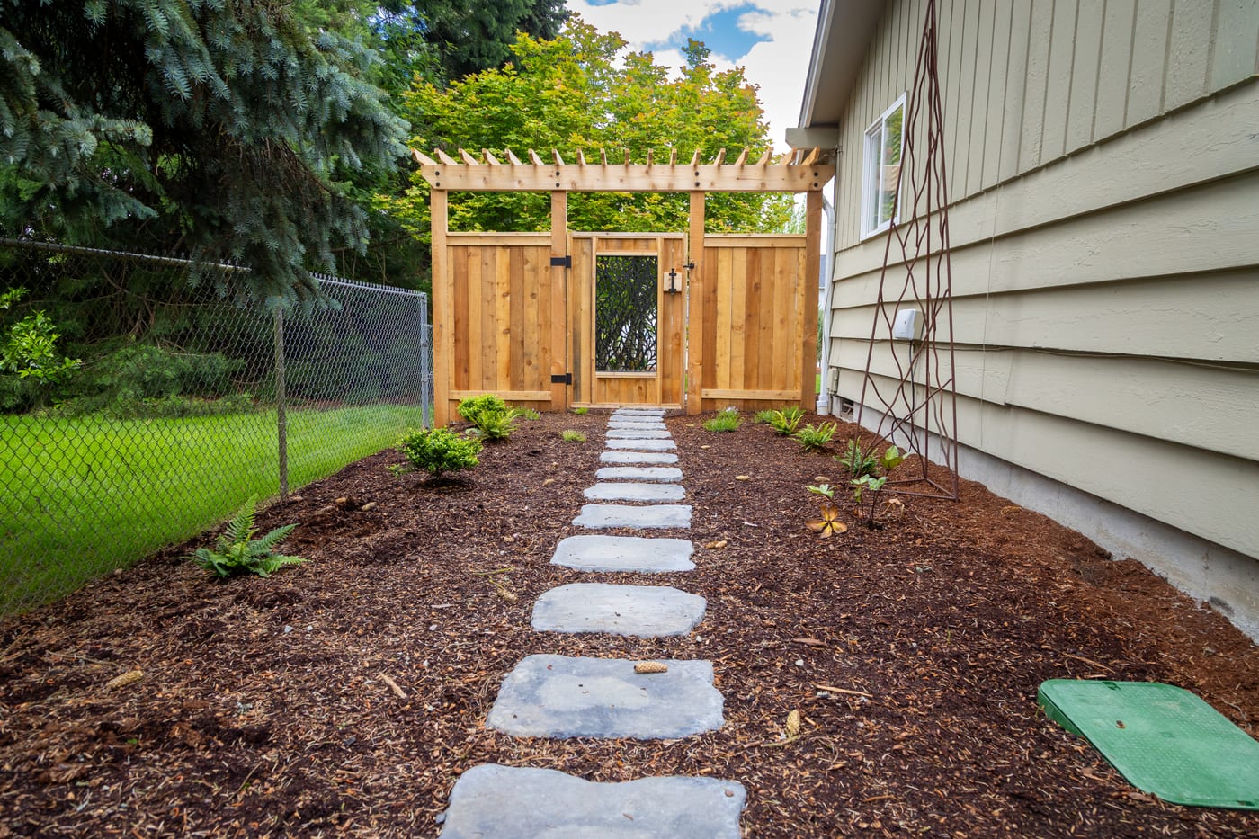 Stepping stones leading along the side yard to the cedar gate